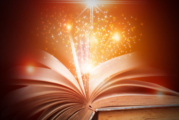 Abstract gold magic book on wooden background