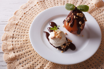 poached pear with chocolate and ice cream. top view horizontal
