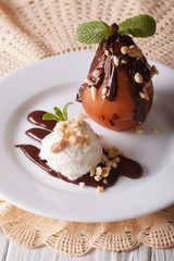 Ice cream with peanuts and pear poured chocolate. vertical
