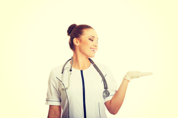 Female doctor presenting copyspace on hand