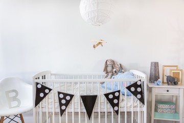 White cot with decoration