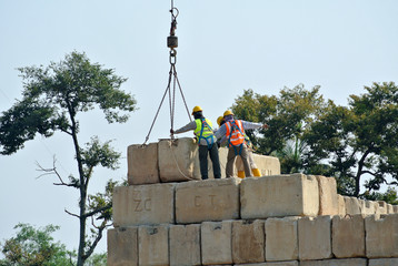 Construction workers stacking the maintain load test block at the construction site 