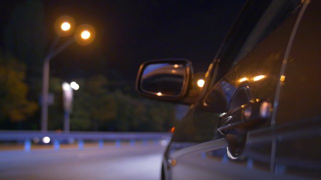 Night car driving outdoor, side camera location on the car body