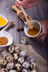 Quail eggs, orange, honey and cinnamon on wood ready for human consumption