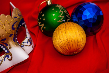 Christmas decorations with a mask on red fabric