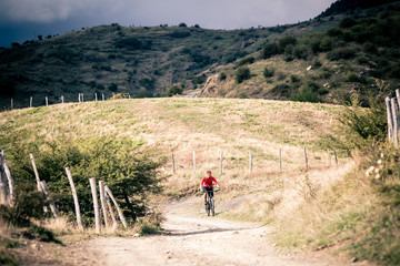 Mountain bike MTB rider on country road, track trail in inspirat