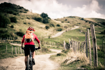 Mountain bike rider on country road, track trail in inspirationa