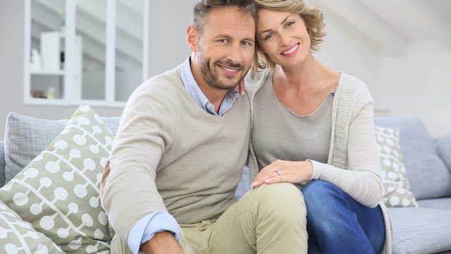 Mature couple relaxing in couch at home