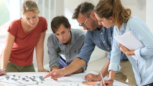Students in architecture working on project with teacher