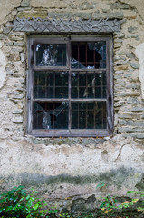Fototapeta na wymiar Window in old abandoned house with broken glass