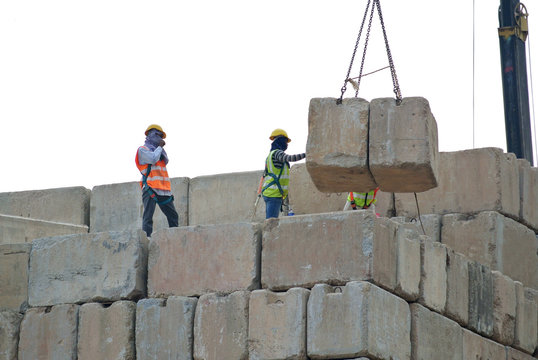 Construction workers stacking the maintain load test block at the construction site 