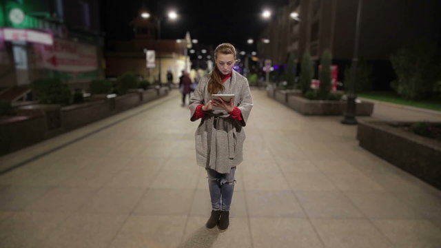 Girl in real time using tablet on the street timelapse background