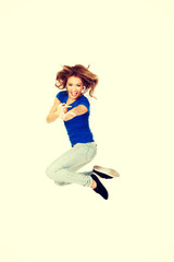 Fototapeta na wymiar Young happy woman jumping.