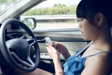 woman driver using a smart phone in car