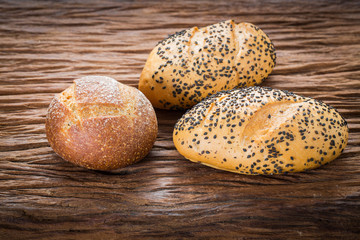 Baked bread on wooden table background.
