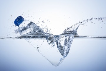 plastic bottle dive with splash into pure water