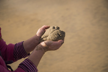 Child holding a sand heart