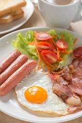 English breakfast with coffee on wood table. Selective focus.