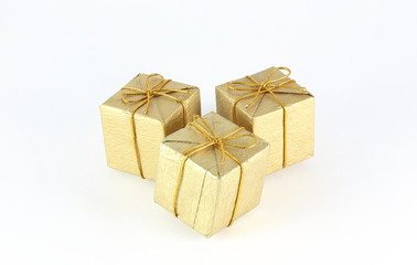 Gift box wrap gold paper with gold ribbon and isolated background