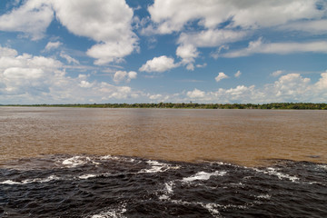 The Meeting of Waters (Encontro das Aguas) is the confluence between the Rio Negro river, with dark water, and lighter Amazon river or Rio Solimoes