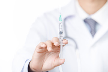 Young Doctor with syringe in his hand