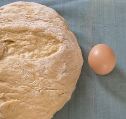 Fresh dough for bread and cakes.egg on the towel