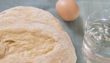 Fresh dough for bread and cakes,egg,water on the towel