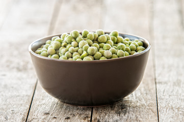 Frozen peas close up on wooden background