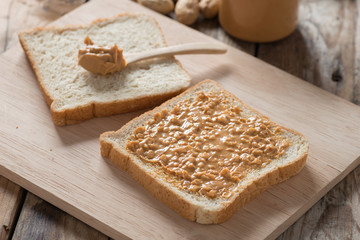 Fototapeta na wymiar Peanut butter sandwich on wood cutting board.