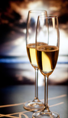 Champagne glasses on tropical beach at sunset - exotic New Year