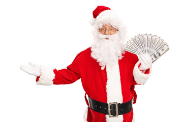 Santa Claus holding a spread of money