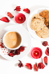 Christmas cup of coffee with cookies and red candle