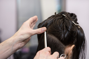 Fototapeta premium A brunette girl having her haircut