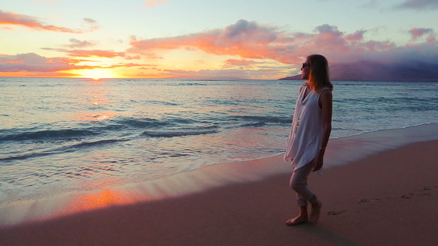 Happy Mature Woman Enjoying a Sunset Walk on the Beach. Vacation Travel Retirement 