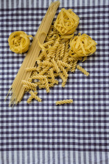 Different noodles on a checkered tablecloth