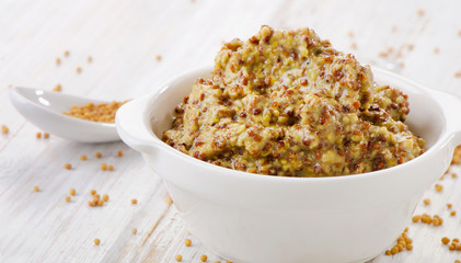 Mustard sauce on wooden table