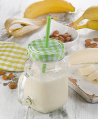 Banana smoothie on a wooden board.