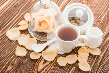 Tea cups with teapot on old wooden table