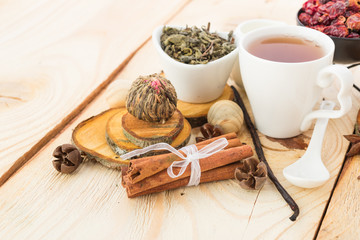 Tea cups with teapot on old wooden table