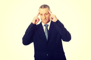 Pensive businessman touching head