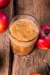 Apple juice and apples on wooden table. Nature apples 