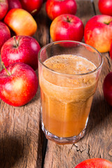 Apple juice and apples on wooden table. Nature apples 