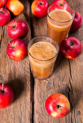 Apple juice and apples on wooden table. Nature apples 