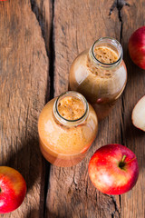 Apple juice and apples on wooden table. Nature apples 