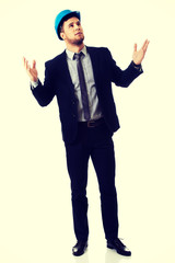 Businessman in hard hat holding copyspace.