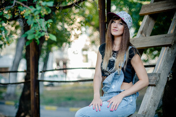 Naklejka premium beautiful girl in denim overalls