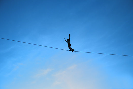 Men balancing on slackline
