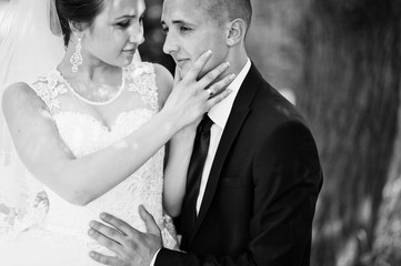 close up portrait of bride holding hand on face groom