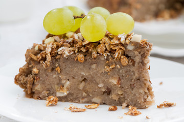 piece of nut pie with grapes on plate