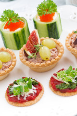 Set of festive Christmas mini appetizers on plate, top view